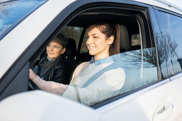 Smiling teen learning to drive